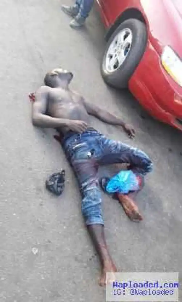 Very graphic photos of armed robber lynched by mob in Ikeja